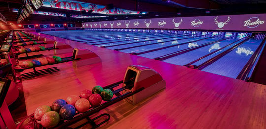 Ball returns and bowling lanes with 'LOVE' written on the wall