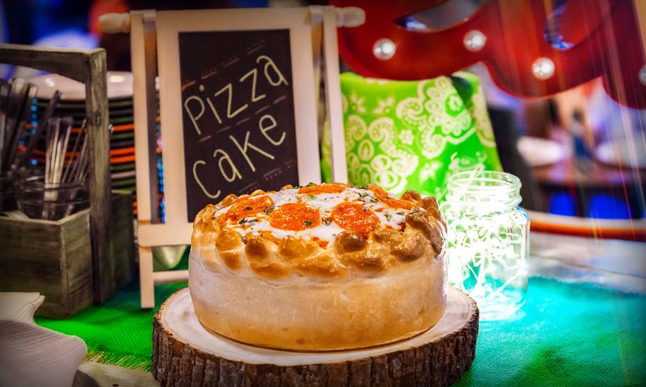 Pizza cake on a wooden block. 