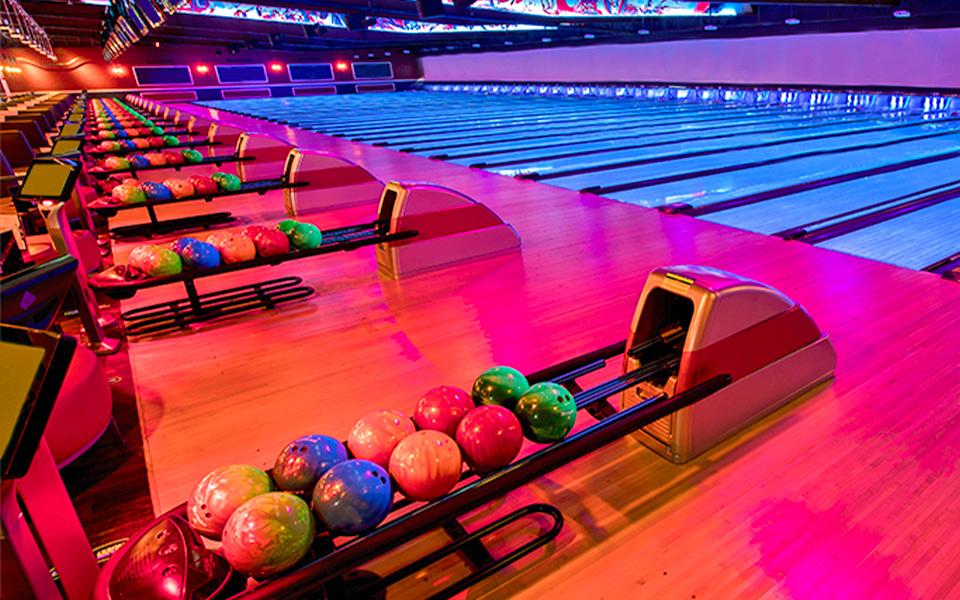 Bowling ball returns with bowling lanes in the background