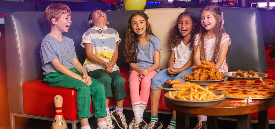 Kids having fun and laughing together with food. 