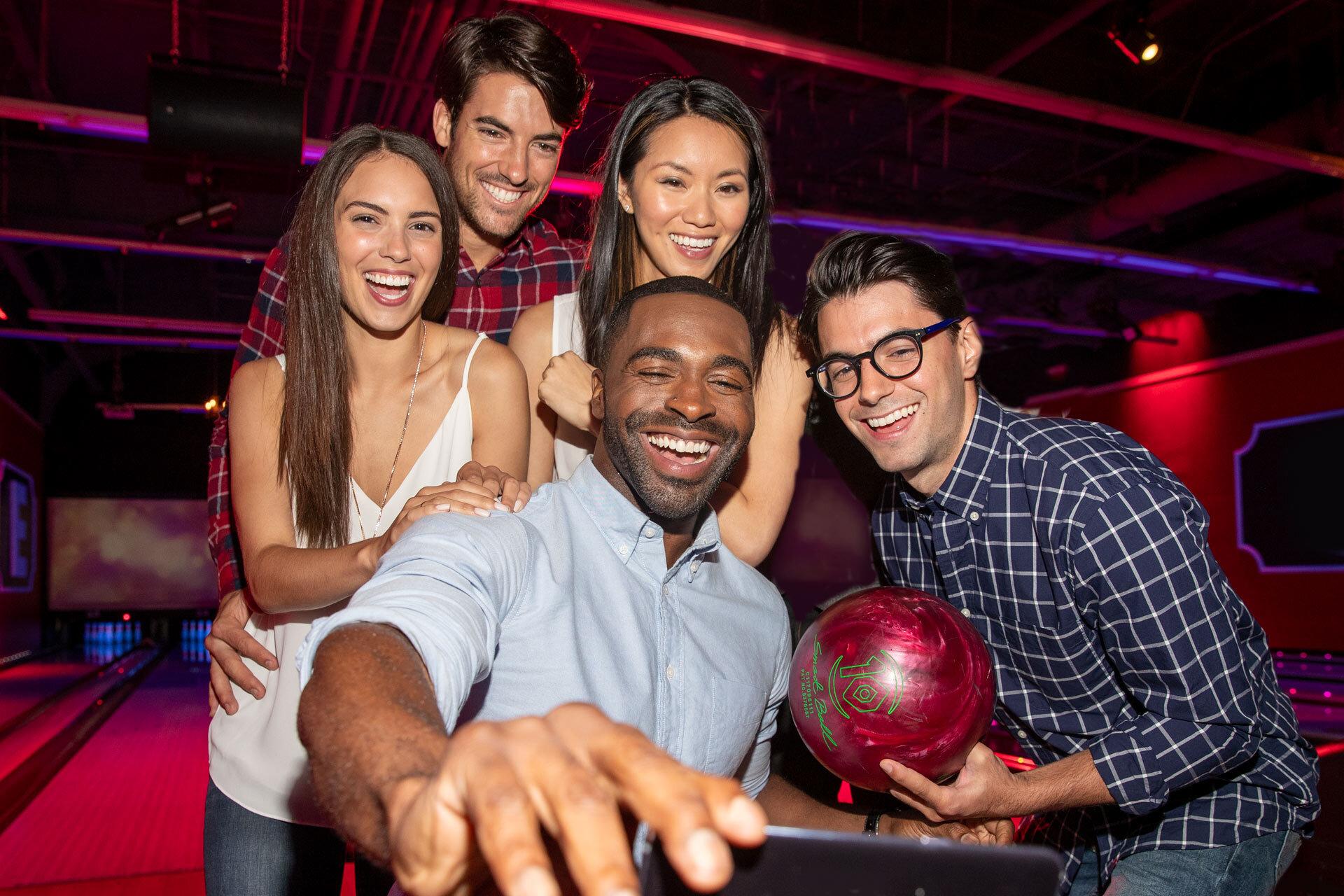 A group of employees taking a selfie on the lanes. 