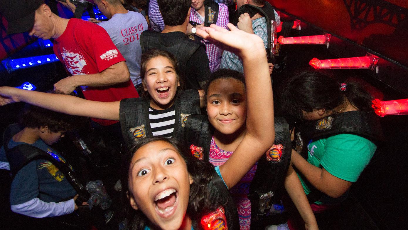 Smiling kids with laser tag gear