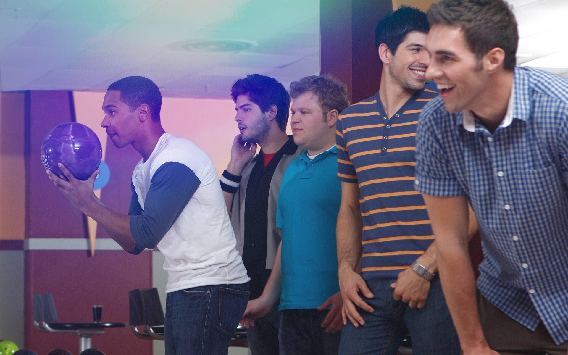 A group of league bowlers having fun bowling.