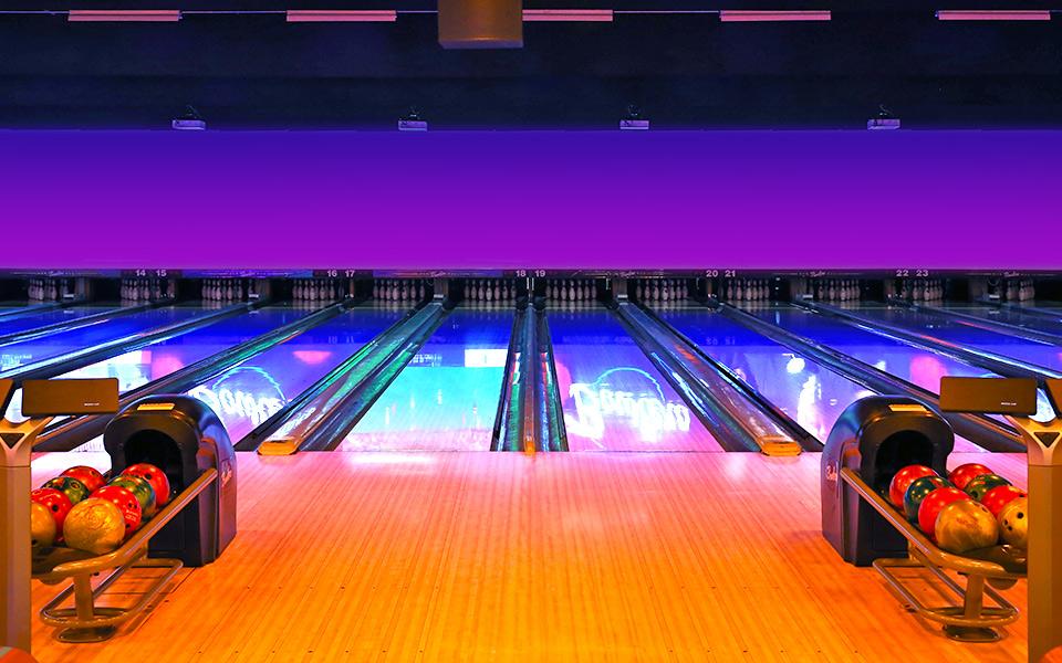 Bowling ball returns with bowling lanes in the background