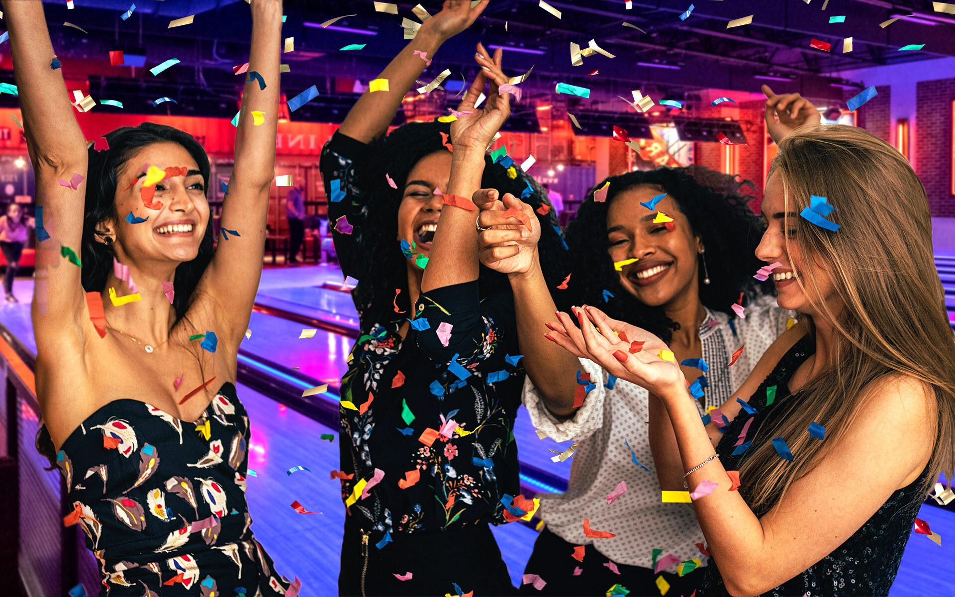 Teens on a bowling lane throwing up confetti 