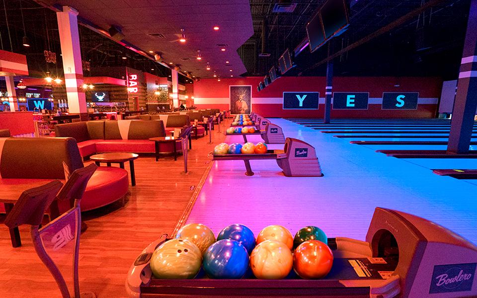 Bowling ball return with bowling center in the background