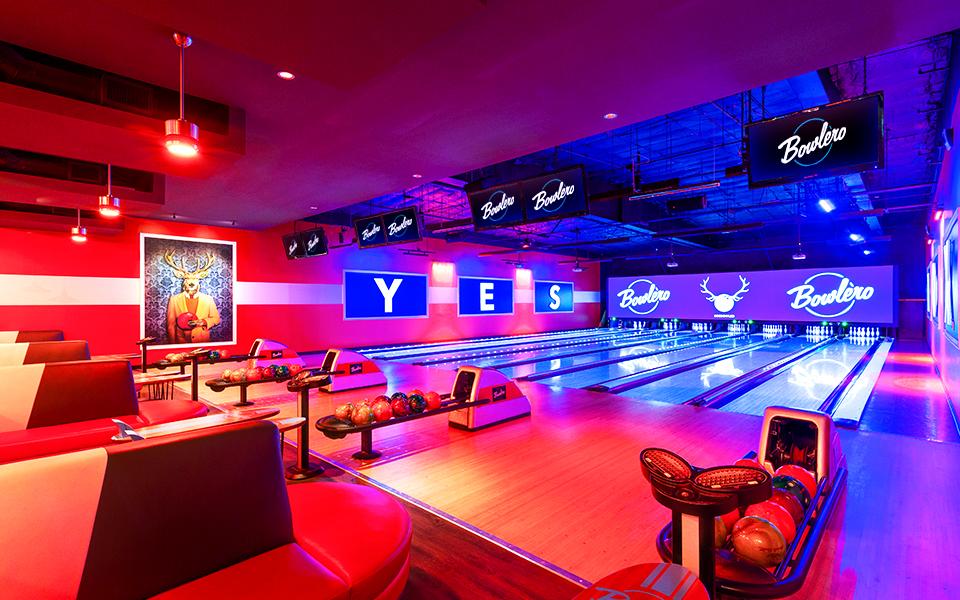 Bowling lanes with Bowlero signs in the background