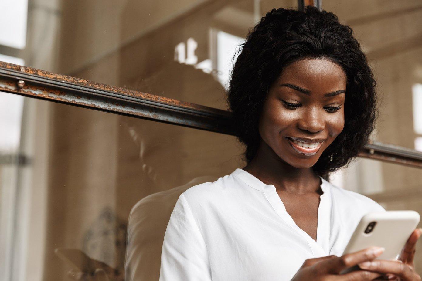 Woman looking at phone and smiling