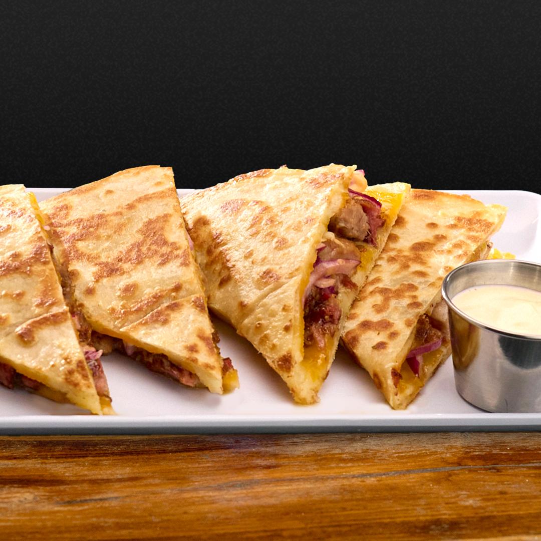 Steak Quesadilla Jack, Cheddar and Mozzarella cheese on a white plate. 