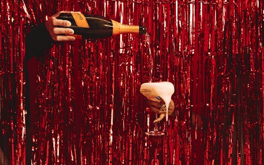 red sparkle background with champagne